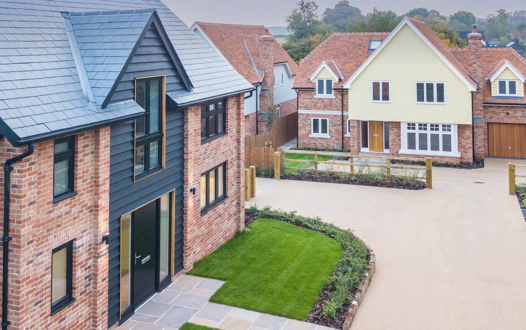 Raised view of the drive-way curving between two houses, Bowditch and Harwood, within the Calvert Close development