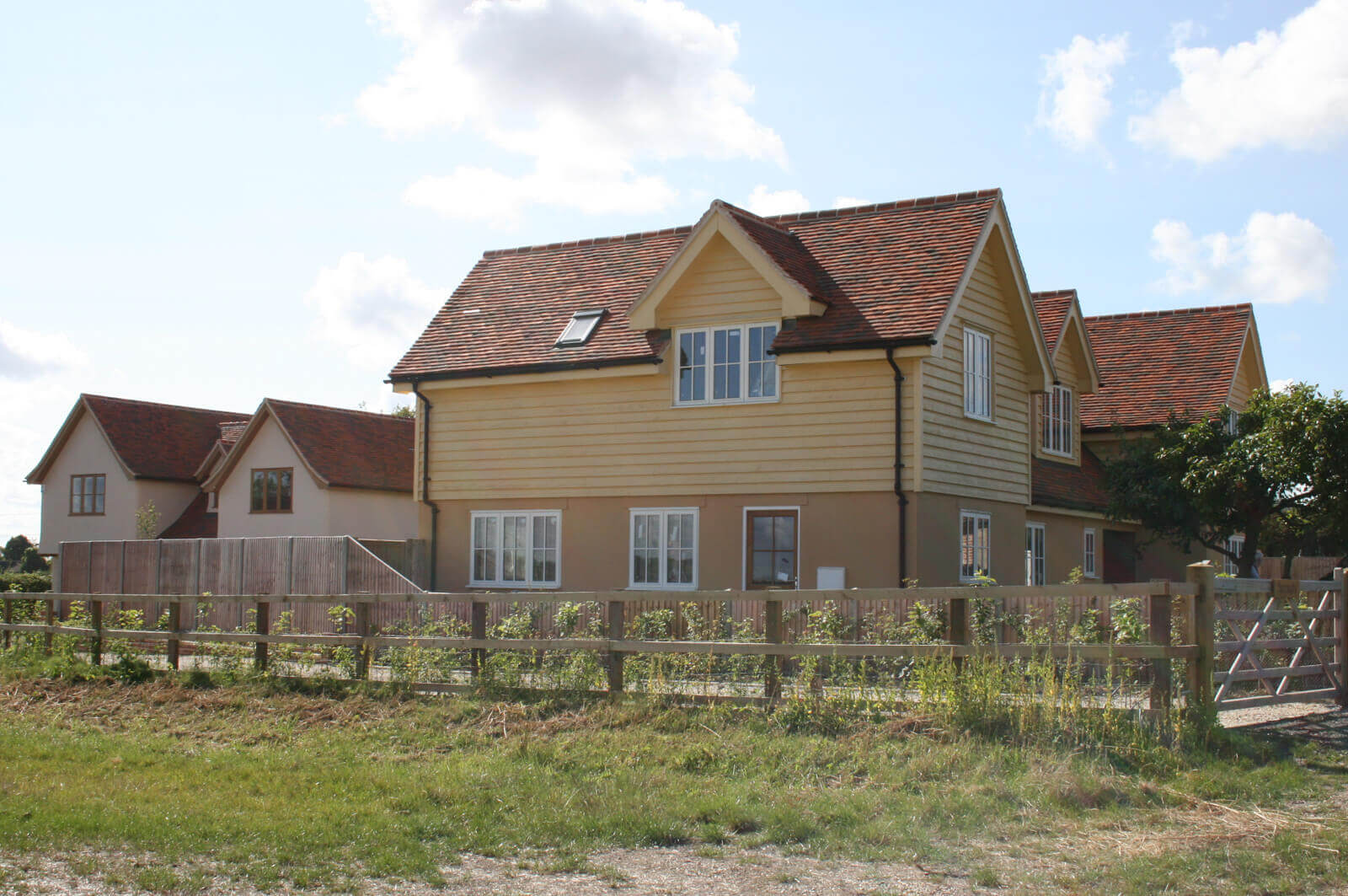 Side view of the house named Belmont, showing side fence and drive way