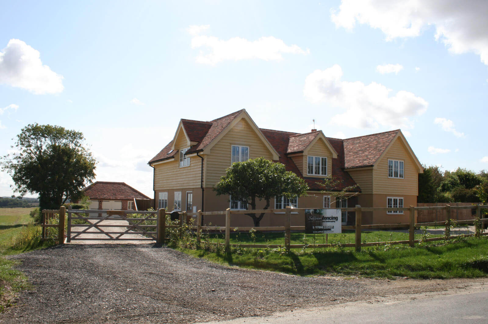 Front view of Belmont, showing surrounding fence and front garden.