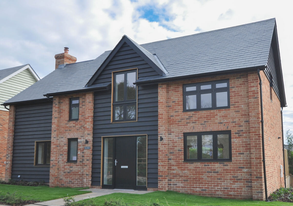 Front view of Bowditch detached house with dark wood panel centre section containing front door.