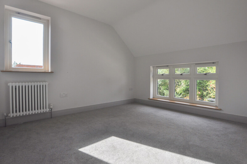 Close up of small bedroom window overlooking trees.