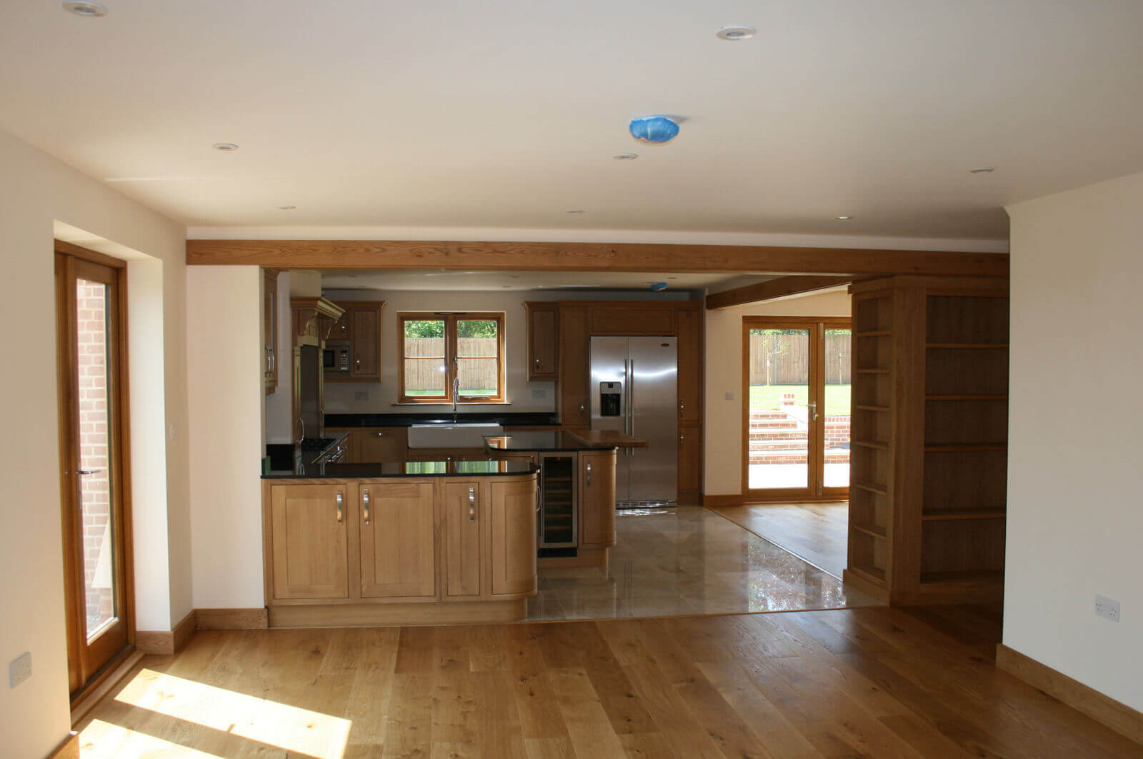 Open plan hard wood floored living room and premium kitchen.