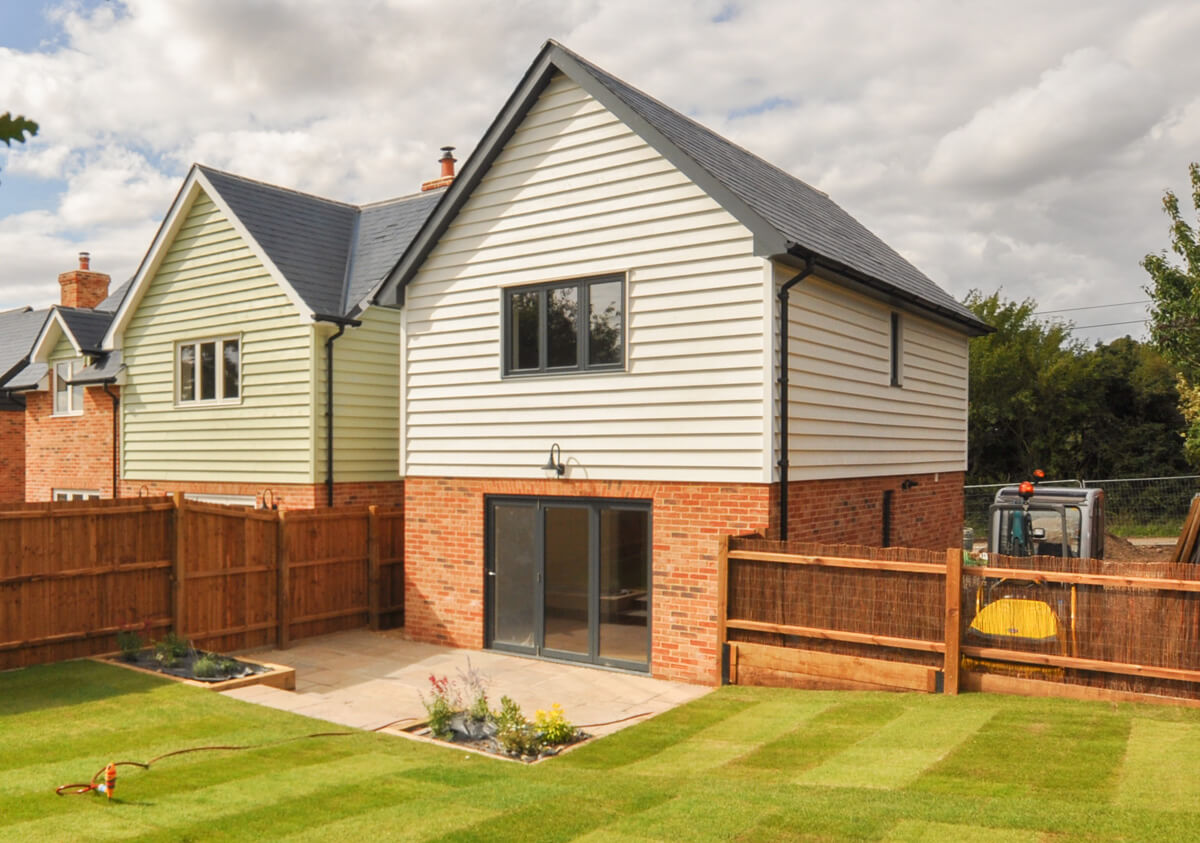 Back view of Drummonds detached house, showing garden and patio area.