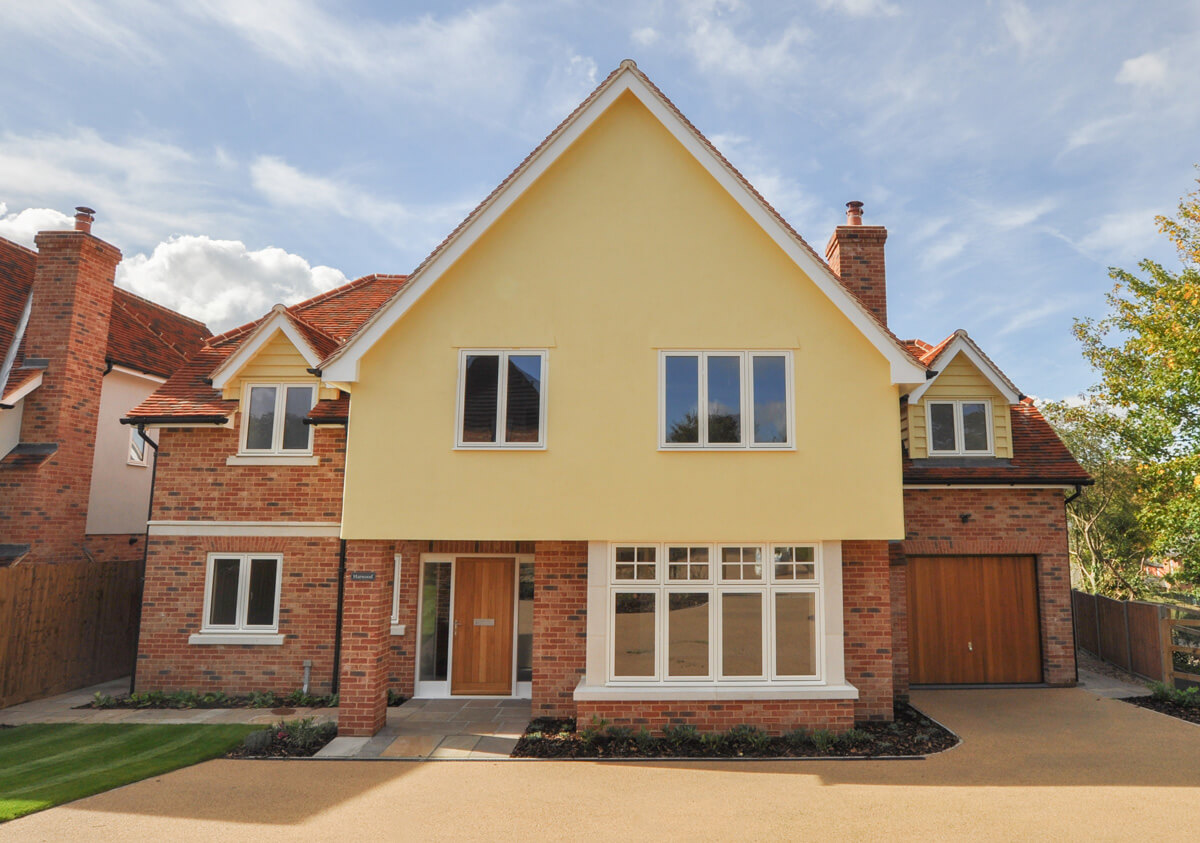 Front view of Harwood detached house, showing driveway and front garden leading to it.