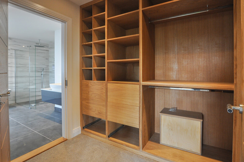 Large wooden walk-in wardrobe.