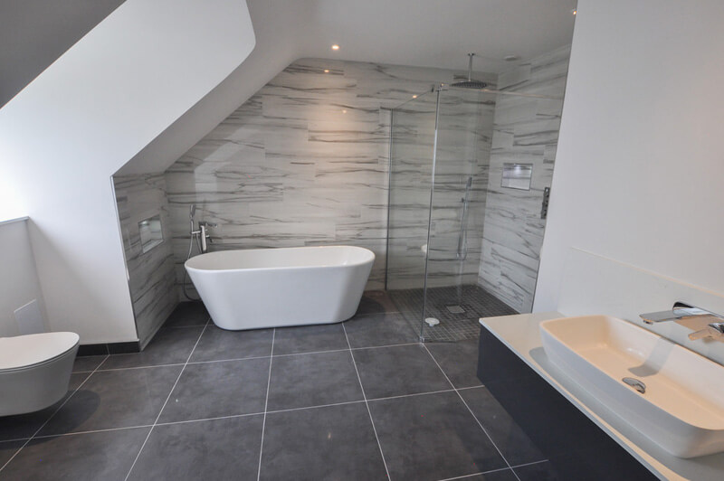 Large premium bathroom with white suite including bath, shower and large sink.