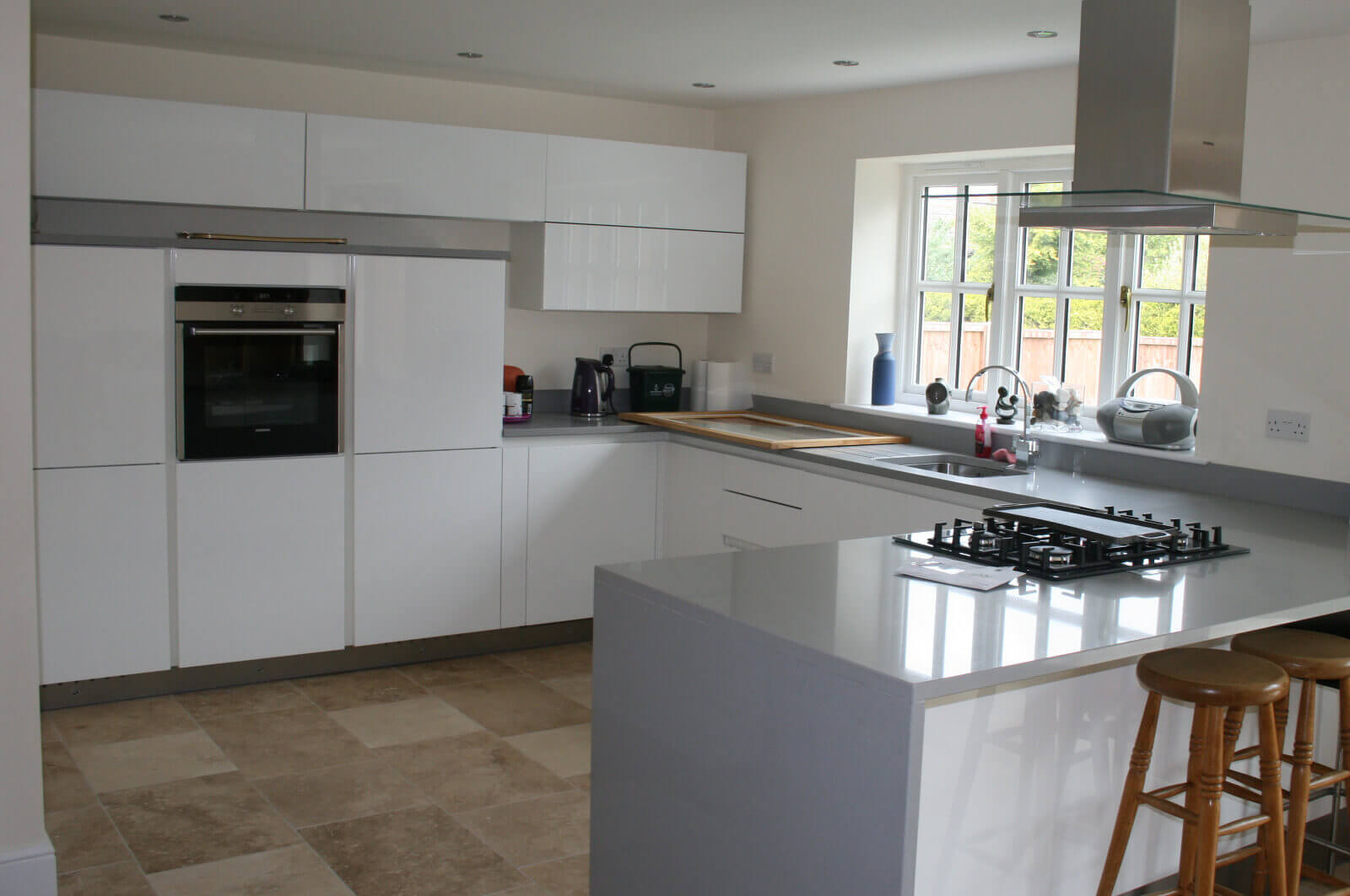 Spacious white kitchen with L-shaped worktop.