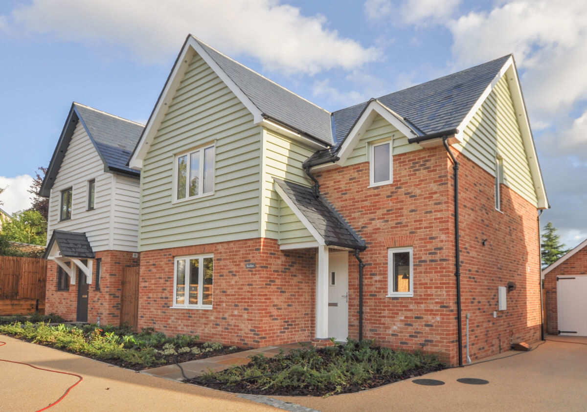 Front view of Rushes detached house, showing drive way and small front garden area.