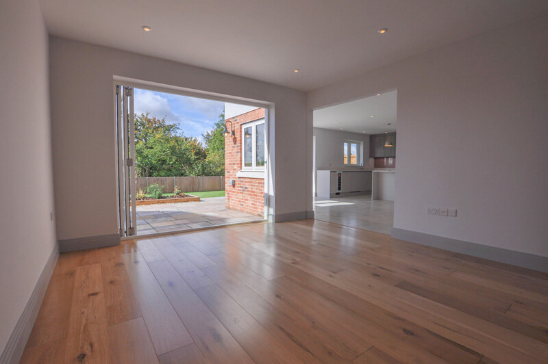 Bright and spacious dining area with hard wood floors and open bi-fold doors leading into back garden.